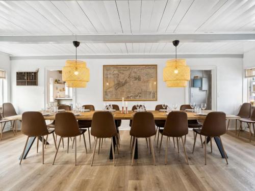 a dining room with a large wooden table and chairs at Holiday Home Dana - 525m from the sea by Interhome in Tranekær