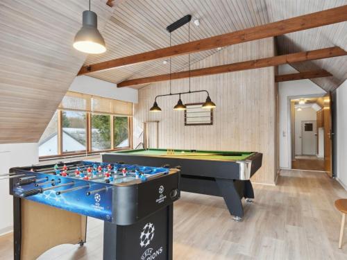 a pool table in a room with a billiard at Holiday Home Dana - 525m from the sea by Interhome in Tranekær