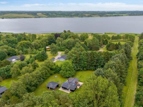 an aerial view of a home with trees and a lake at Holiday Home Gudrid - 250m to the fjord by Interhome in Højslev