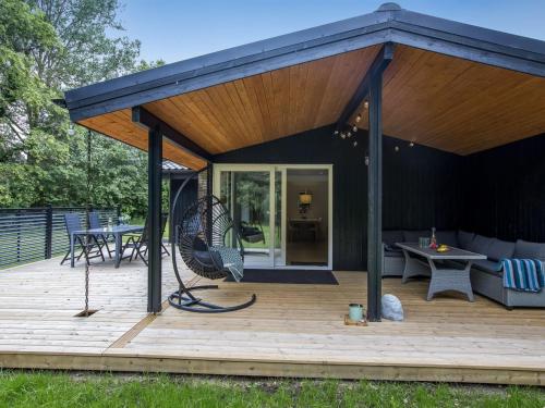 a pavilion with a deck with a bench and a table at Holiday Home Gudrid - 250m to the fjord by Interhome in Højslev