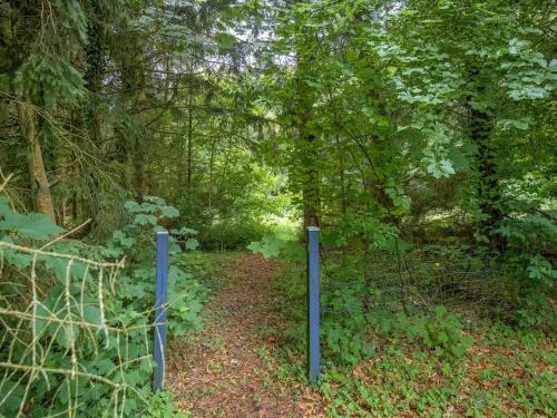 a trail in the woods with two blue poles at Holiday Home Gudrid - 250m to the fjord by Interhome in Højslev