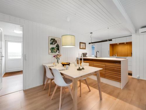 a kitchen and dining room with a table and chairs at Holiday Home Gudrid - 250m to the fjord by Interhome in Højslev