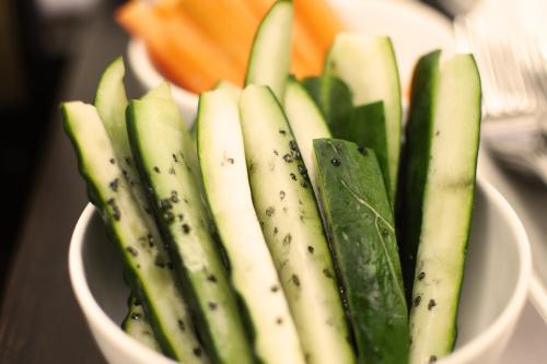 a white bowl filled with green vegetables on a table at Das Alte Rathaus in Egna