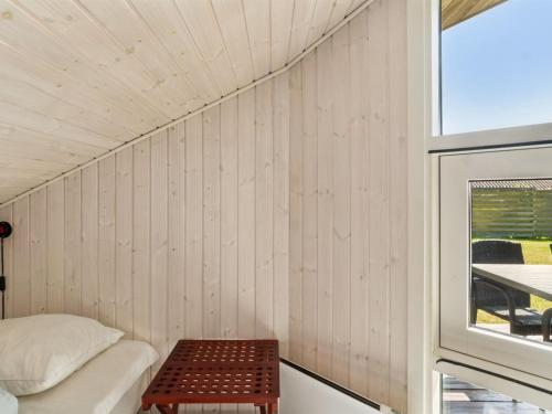a small room with a bed and a table at Holiday Home Thrym - 200m from the sea by Interhome in Store Fuglede