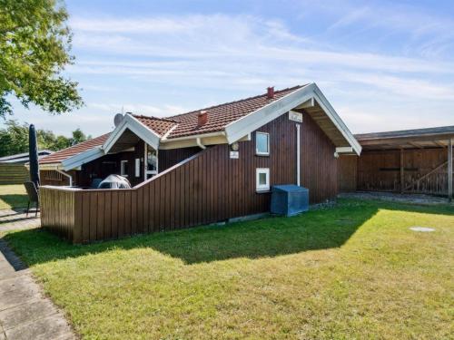 a house with a fence and a yard at Holiday Home Thrym - 200m from the sea by Interhome in Store Fuglede
