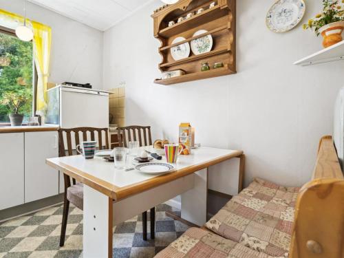 a small kitchen with a table and chairs at Holiday Home Magh - 9-8km from the sea by Interhome in Tønder