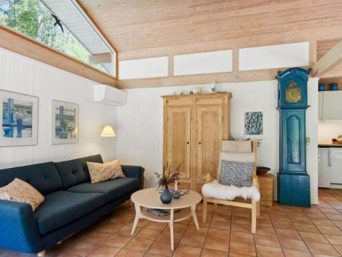 a living room with a couch and a table at Holiday Home Judyta - 250m to the inlet by Interhome in Nakke