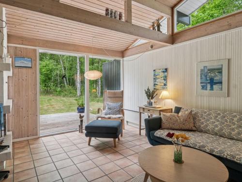 a living room with a couch and a table at Holiday Home Judyta - 250m to the inlet by Interhome in Nakke