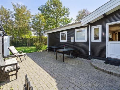 a patio with a table in front of a house at Holiday Home Imma - from the sea by Interhome in Karrebæksminde