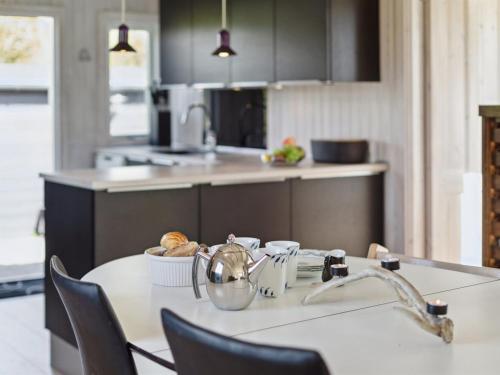 a kitchen with a table with a bowl of food on it at Holiday Home Imma - from the sea by Interhome in Karrebæksminde