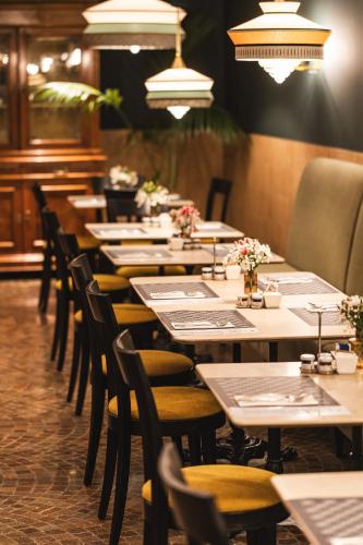 a row of tables and chairs in a restaurant at Casa D'Este - Hotel Ferrara in Ferrara