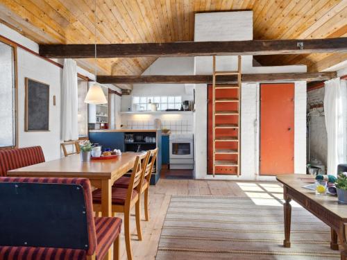 a kitchen and dining room with a wooden ceiling at Holiday Home Bedri - 100m from the sea by Interhome in Læsø