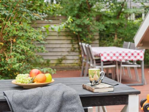 a wooden table with a plate of fruit on it at Holiday Home Ninni - 3-2km from the sea by Interhome in Eskebjerg