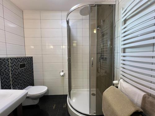 a bathroom with a shower and a toilet and a sink at Rendez-vous in Kielce