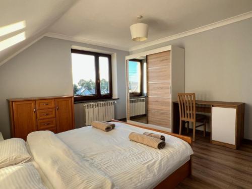 a bedroom with a bed and a desk with a chair at Rendez-vous in Kielce