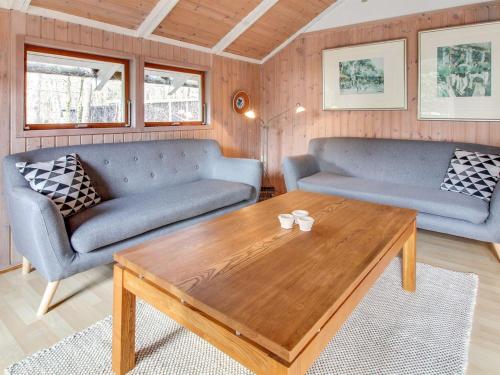 a living room with two couches and a coffee table at Holiday Home Anttoni - 50km from the sea by Interhome in Ansager