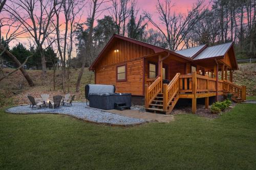 a log cabin with a deck and a grill at 3 minutes to downtown, Hot Tub, Loft, Minutes to wineries in Ellijay