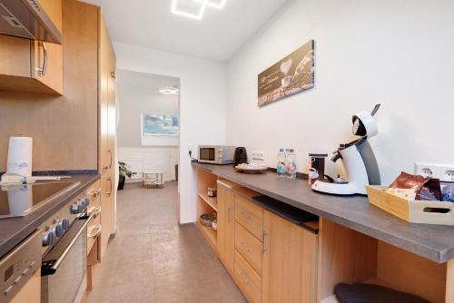 a kitchen with wooden cabinets and a counter top at Ferienwohnung Rosengarten in Mössingen