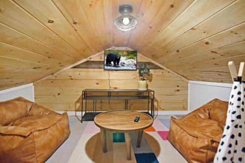 a living room with a couch and a table at 3 minutes to downtown, Hot Tub, Loft, Minutes to wineries in Ellijay