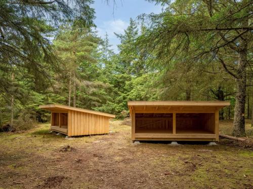 two woodensheds in the middle of a forest at Holiday Home Sylwia - from the sea by Interhome in Ulfborg