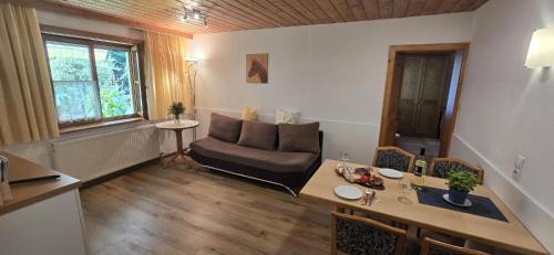 a living room with a table and a couch at Ferienwohnung Auer Kitzbüheler Alpen ITD099 in Itter