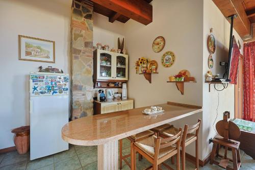 a kitchen with a table and a refrigerator at Bed And Breakfast Sciarammola in Patti