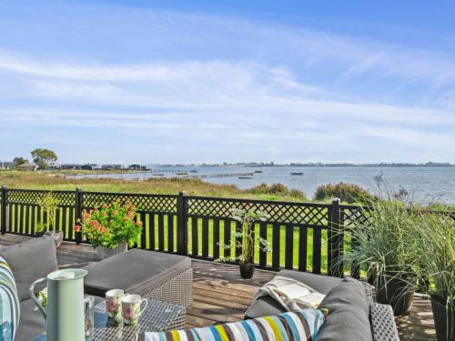 a patio with a view of the water at Holiday Home Gyrth - 20m to the inlet by Interhome in Munkebo