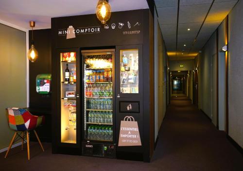 a store with a drink cooler in a hallway at Campanile NATURE - Clermont-Ferrand Nord Riom in Riom