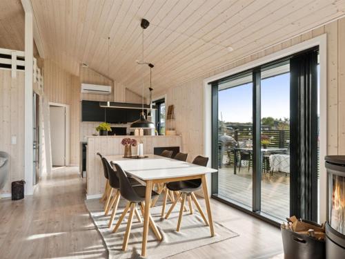 a kitchen and dining room with a table and chairs at Holiday Home Brothir - 500m from the sea by Interhome in Odder