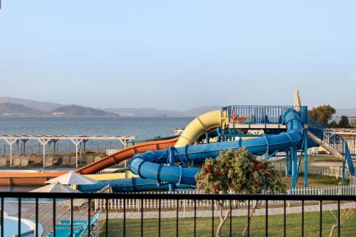 a water slide in a park next to the water at White Olive Marine Aquapark in Tigaki