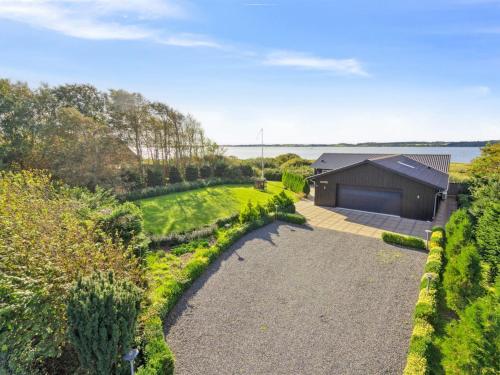 an aerial view of a house with a driveway at Holiday Home Berta - 70m to the fjord by Interhome in Roslev