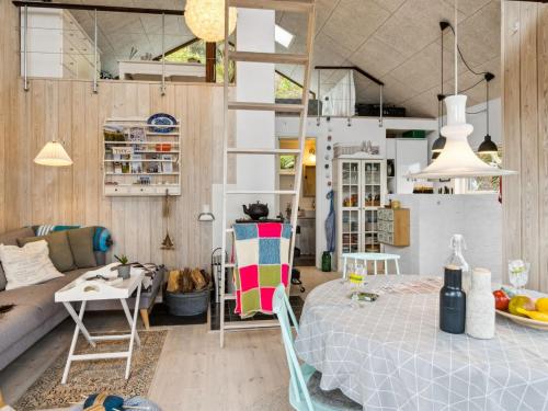 a room with a bed and a living room at Holiday Home Benni - 75m to the inlet by Interhome in Løgstør