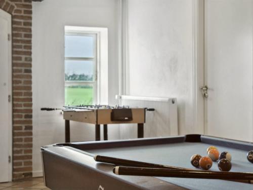a room with a pool table and a piano at Holiday Home Haralde by Interhome in Bredebro