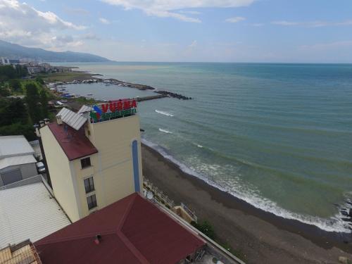a building on the beach next to the ocean at Vurna Butik Hotel in Trabzon