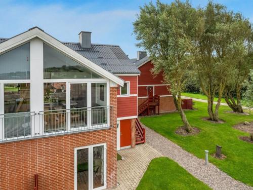 a red brick house with a large window at Apartment Alvy - 100m to the inlet by Interhome in Lemvig