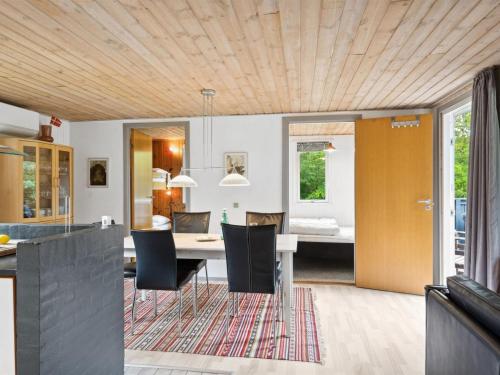 a kitchen and dining room with a table and chairs at Holiday Home Sunaj by Interhome in Fårvang