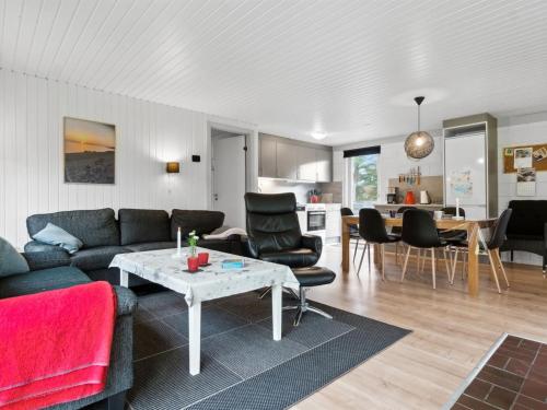 a living room with a couch and a table at Holiday Home Pia - 250m to the fjord by Interhome in Sindrup