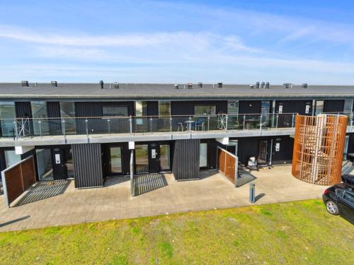 an external view of a building with a deck at Apartment Kimi - 100m from the sea by Interhome in Havneby