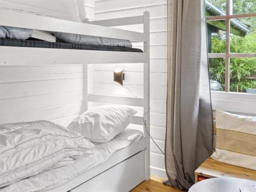 a bed in a room with a window at Holiday Home Neela - 300m from the sea by Interhome in Marielyst