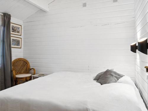 a bedroom with white walls and a white bed at Holiday Home Neela - 300m from the sea by Interhome in Marielyst