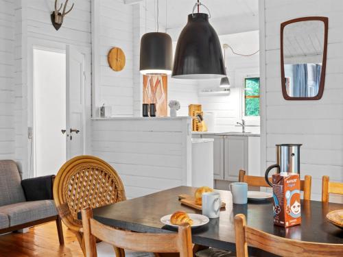 a kitchen and dining room with a table and chairs at Holiday Home Neela - 300m from the sea by Interhome in Marielyst