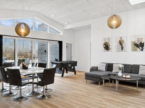 a living room with a table and a pool table at Holiday Home Nissine - 300m from the sea by Interhome in Odder