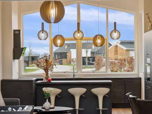 a kitchen with a bar with a large window at Holiday Home Nissine - 300m from the sea by Interhome in Odder