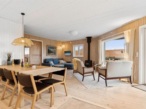 a dining room and living room with a table and chairs at Holiday Home Marlies - 300m from the sea by Interhome in Allinge