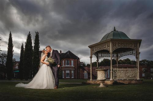 a bride and groom standing in front of a gazebo at Best Western Plus West Retford Hotel in Retford