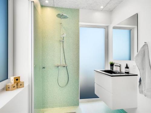 a bathroom with a shower and a sink at Holiday Home Unge - 75m from the sea by Interhome in Torsted