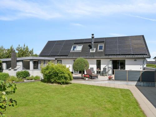 a house with solar panels on the roof at Holiday Home Alona - 90m from the sea by Interhome in Allingåbro