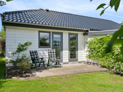 two chairs in front of a tiny house at Holiday Home Alona - 90m from the sea by Interhome in Allingåbro