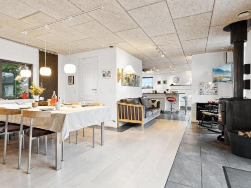 a kitchen and living room with a table and chairs at Holiday Home Alona - 90m from the sea by Interhome in Allingåbro
