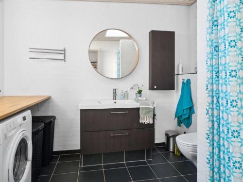 a bathroom with a sink and a washing machine at Holiday Home Els - 1-8km from the sea by Interhome in Fårevejle